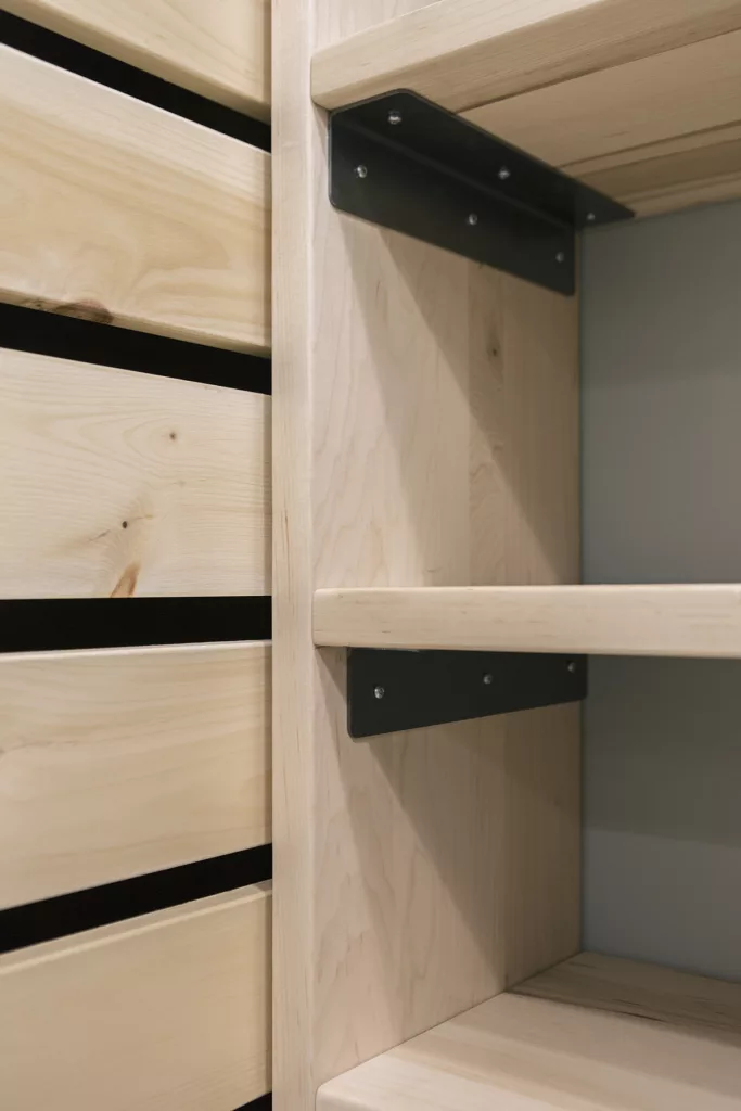 Coin de tablettes de bois naturel avec des braquettes d'acier noir.